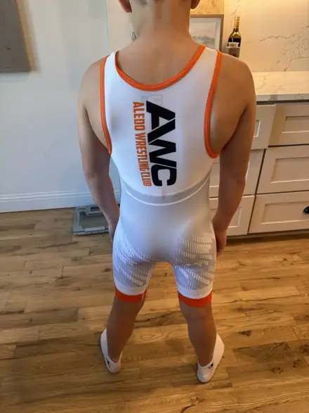 The white AWC club singlet with the club logo across the chest