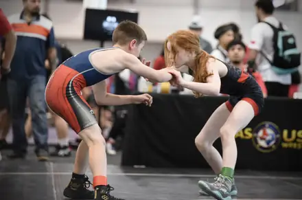 Two wrestlers hand fight during a match at a Texas USA Wrestling event