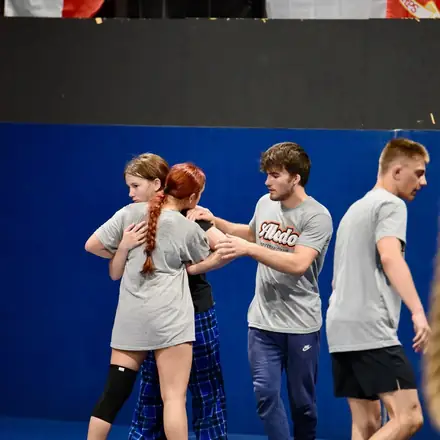 Teenage AWC wrestlers drilling a set-up in pairs.