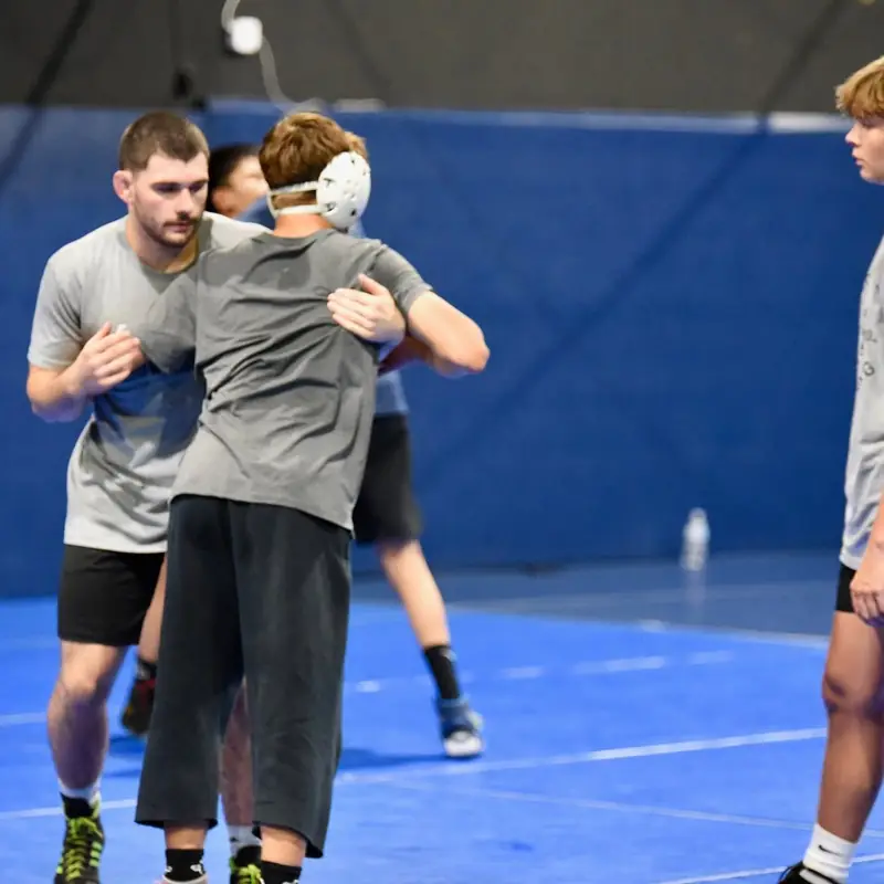 Two older AWC athletes in a tie-up during a live round.