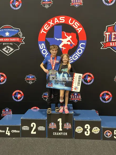 AWC wrestlers on the awards podium at a Texas USA Wrestling event