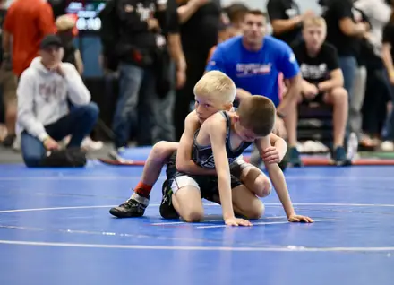 Two young boys in the down position at the start of a period
