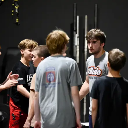 AWC athletes gathered together talking between rounds.