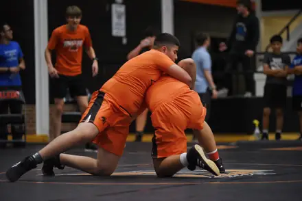 Two Aledo wrestlers drilling takedowns during a practice session in the gym