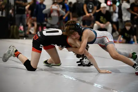 A young wrestler defends a shot on the tournament mat