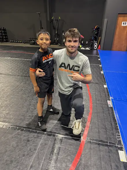 AWC wrestlers and coaches together in club gear after a session