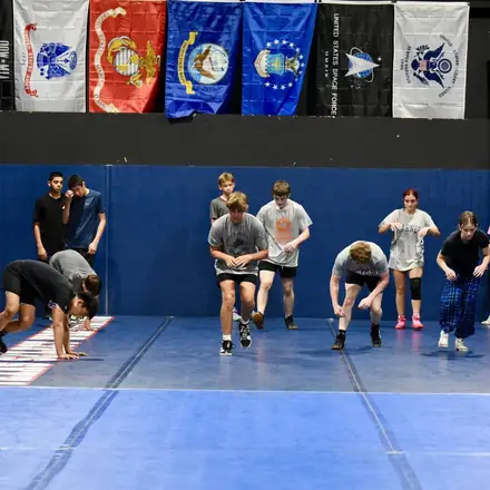 A wide shot of the AWC mat room with the whole group drilling.