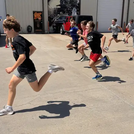 An AWC athlete leading an outdoor sprint interval.