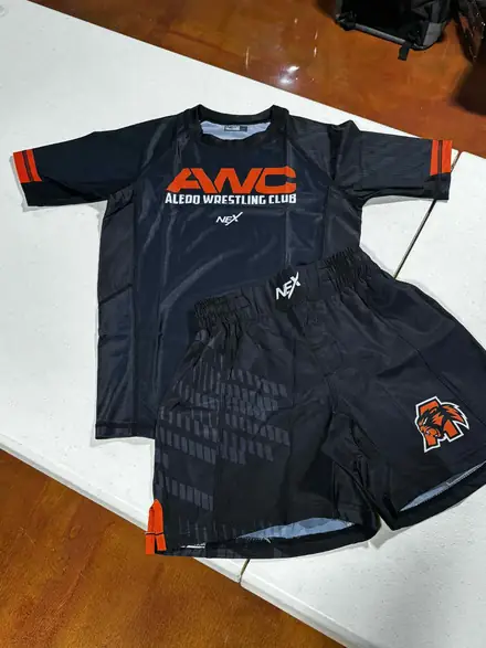 The black AWC competition shirt and club shorts laid out