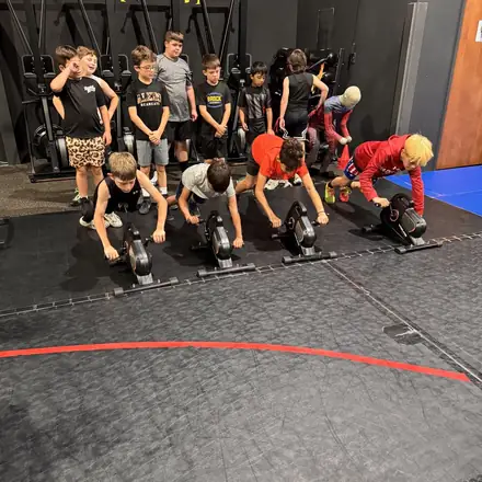 A wide view of a sled push circuit during strength and conditioning.