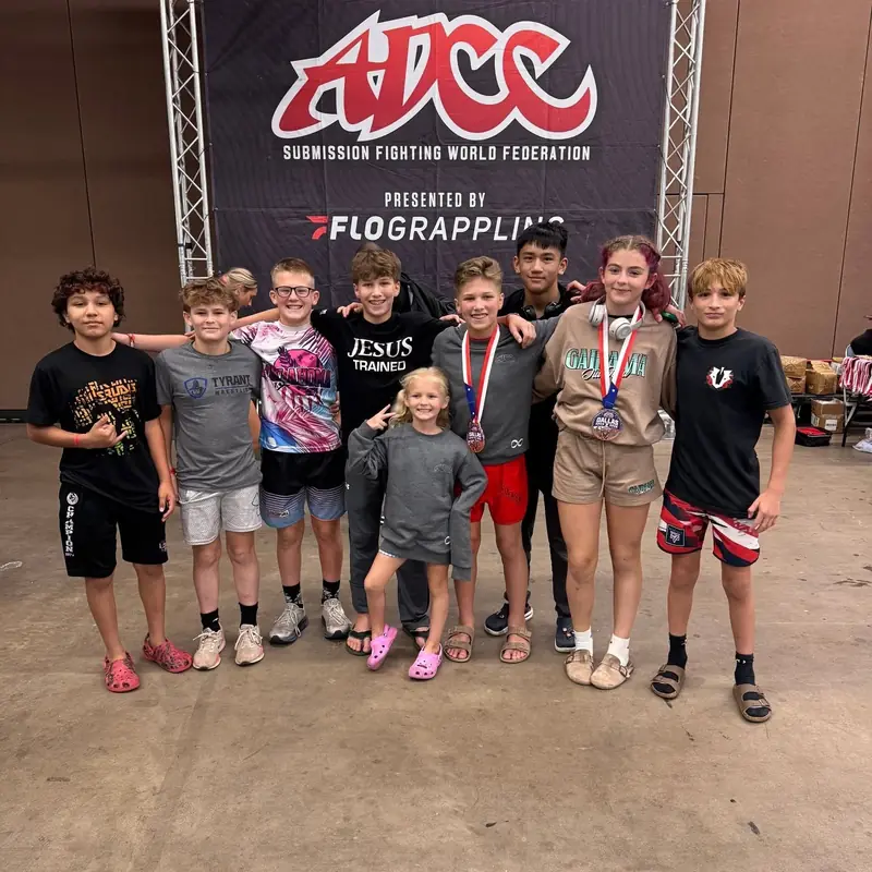 An AWC team group photo with medals after a tournament.