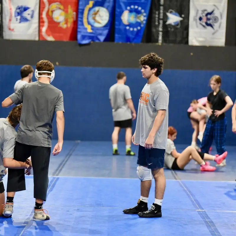 Live wrestling across the full mat during an AWC practice.