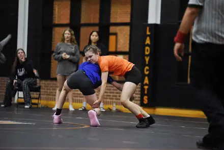 Two Aledo wrestlers going live during a practice session in the gym