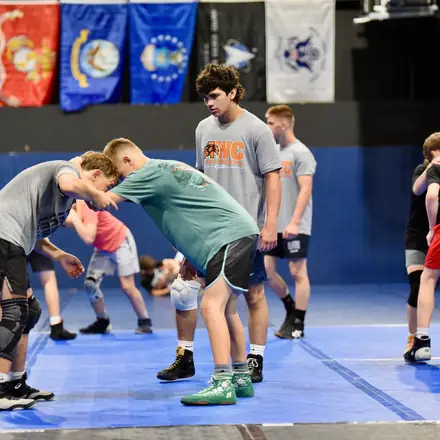 Two AWC wrestlers scrambling for position on the mat.